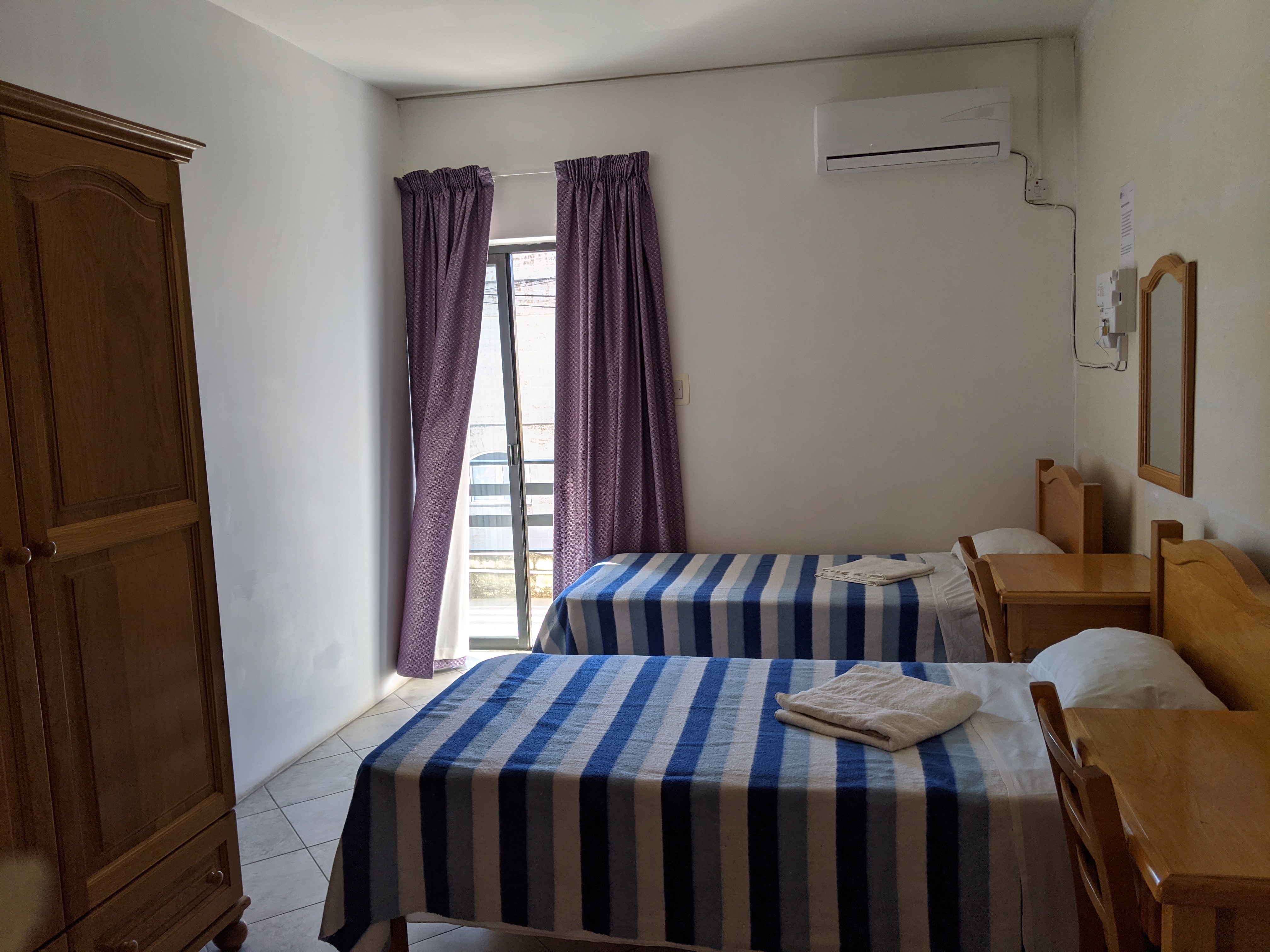 Study English in Malta - GSE Residence bedrooms next to school triple room with balcony